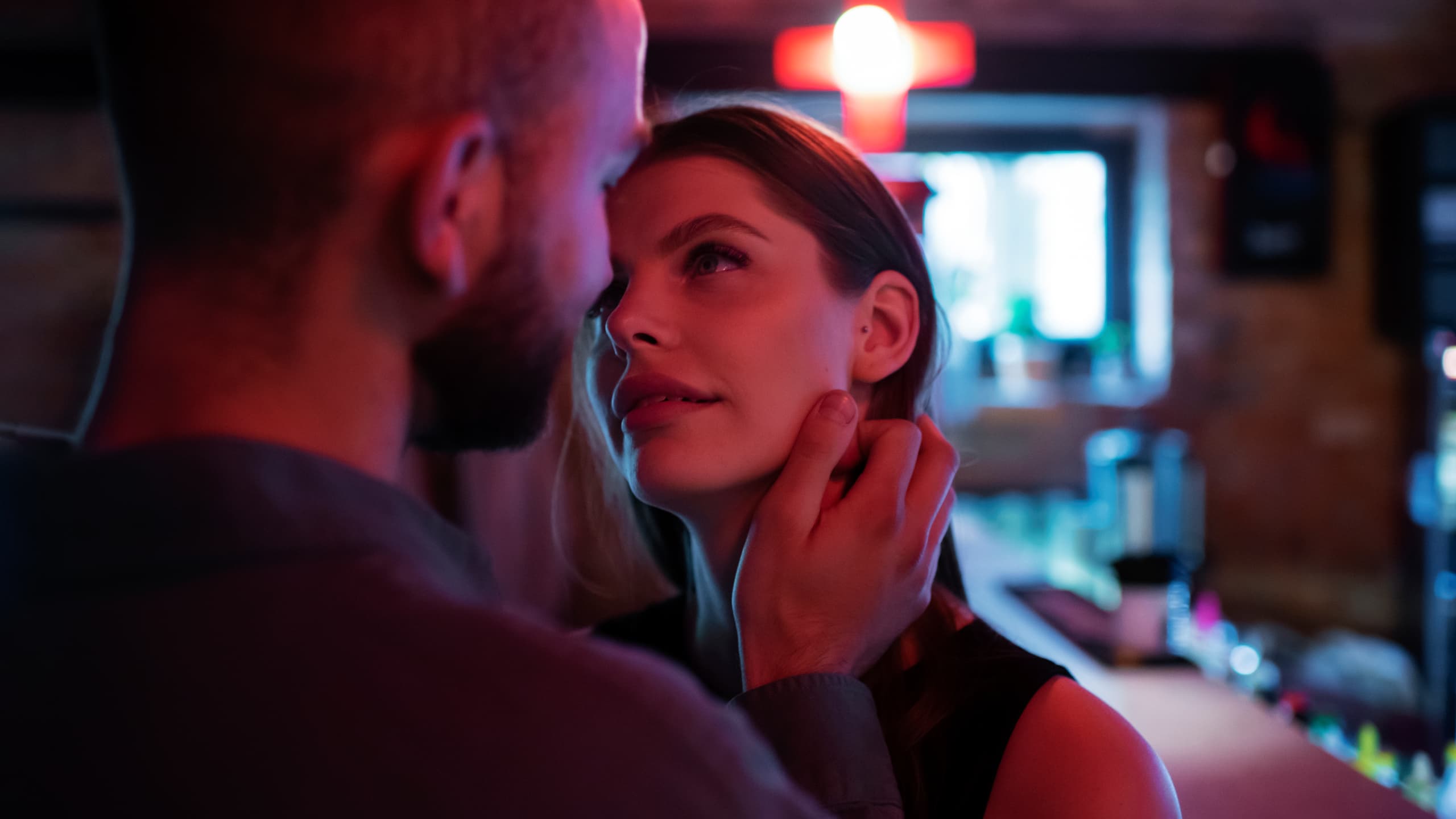 A man touching a womans' cheek.