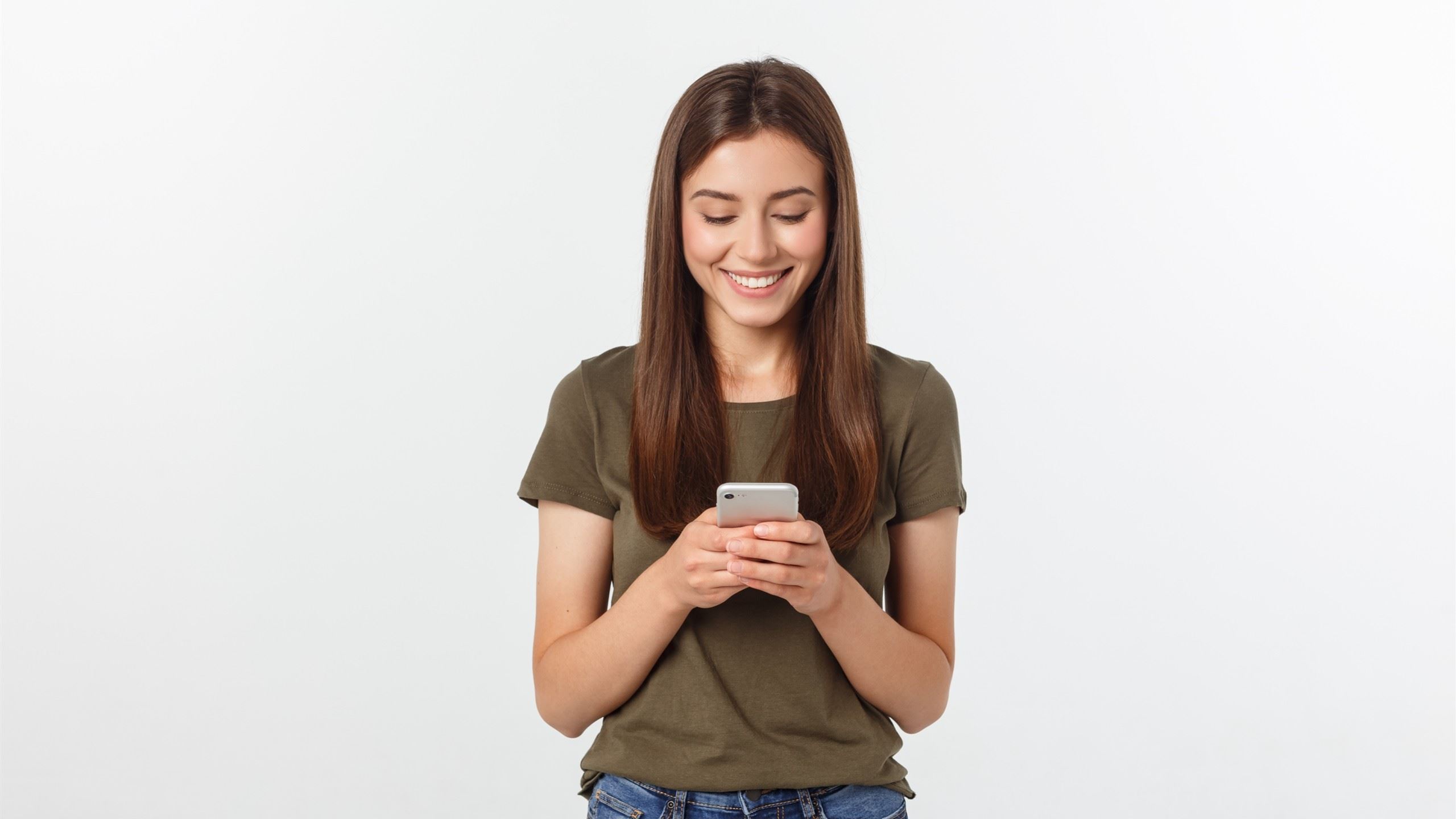 A cute woman smiling while texting.